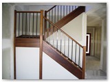 Closed-rise-stairs-with-timber-handrails-and-powdercoated-balusters